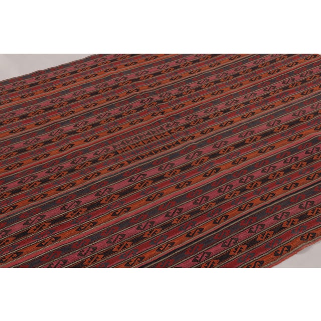 Made with handwoven wool circa 1950-1960, this 5x6 vintage flat-weave Kilim is a particularly intricate and sought-after...