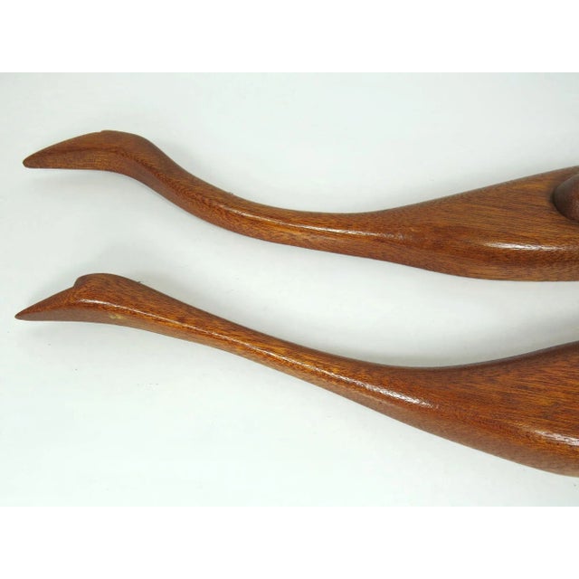 Set of 2 vintage teak cranes or herons wall decor with a light walnut stain. Dimensions: 21"W x 1.63"D x 4.5"H; 17.5"W x...