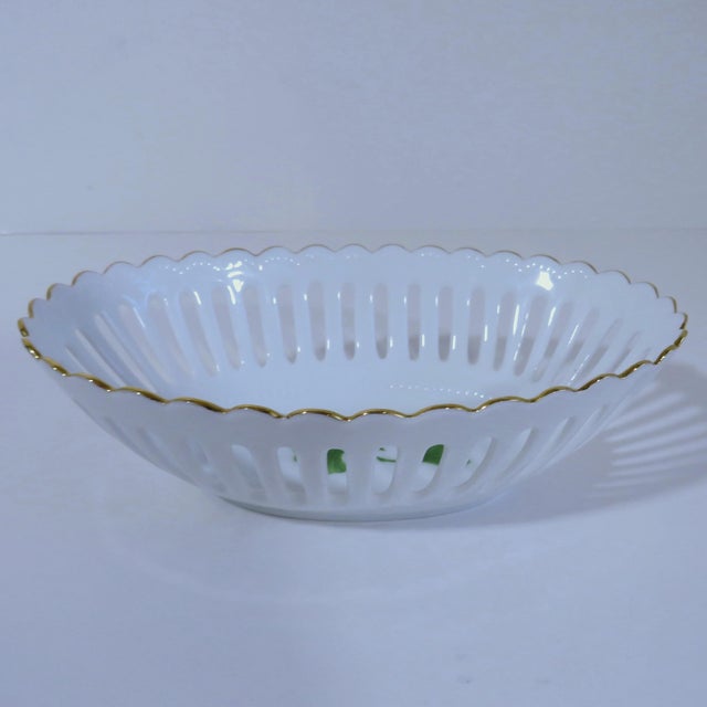 Vintage Bavarian white porcelain oval-shape bowl with delicate openwork design and two hand-painted green ginkgo leaves....