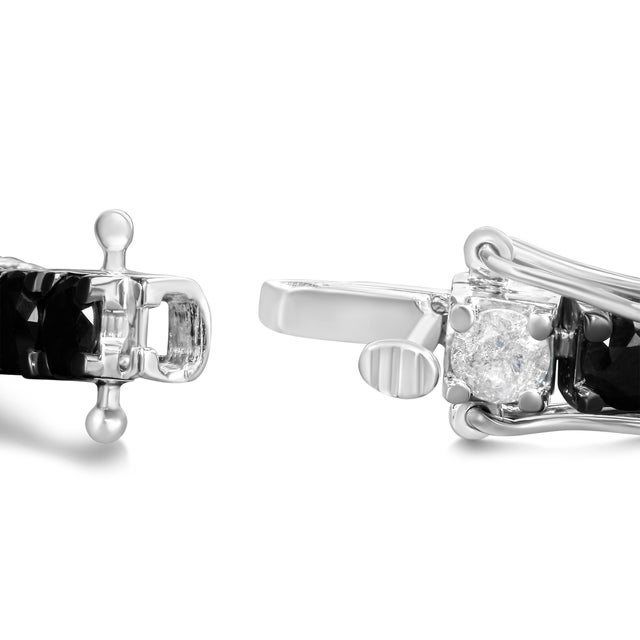 Elevate your style with this striking .925 sterling silver tennis bracelet, featuring a dazzling 12.0 carats of natural...