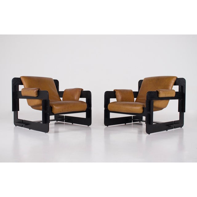 Pair of Rover armchairs, designed by Arne Jacobsen for Asko, Finland, circa 1968. The stained ash plywood frame is...