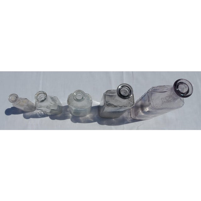 Beautiful matching collection of 5 authentic antique pharmacy and medicine bottles dating from the late 1800s to early...