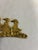 A charming vintage brass wall hook with three ducks in a row, their bodies richly textured to suggest feathers. Two small...