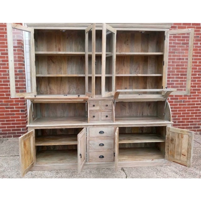 This kitchen pantry is a large cupboard crafted from solid wood with a driftwood finish, featuring a buffet and a 2-piece...