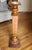 A slender wood pedestal stand with a turned bulbous and tapered shaft incised with a stylized urn and foliate motif. No...