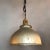 Industrial pendant light features a X-Ray mercury glass, dome shade painted silver on it's exterior with brass switch...