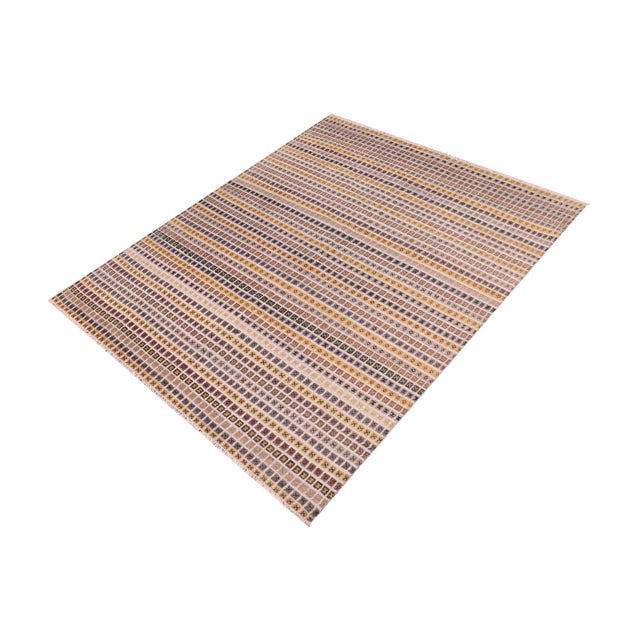Elevate your interior with this hand-knotted high-low wool area rug, designed to bring depth and dimension to any room....