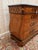 A bombé commode in the swiss style, dating from the 19th century, with a tomb-like silhouette and curved sides. the front...