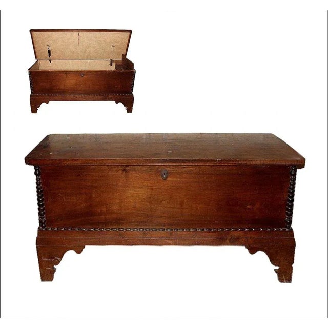 Solid walnut chest in first patina belonging the early 18th century. A mixed grinbiale connects the two smelled feet while...