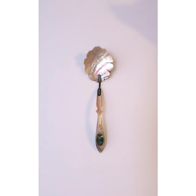 A beautiful mother of pearl spoon with abalone seashell and sterling silver detail, Victorian design period, circa turn-...
