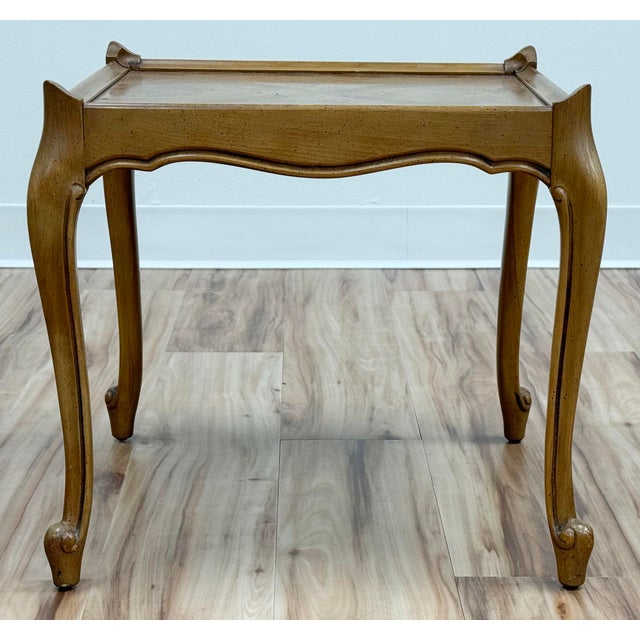 Vintage French Provincial style burled wood table featuring curved legs and frame with X cross detail to tabletop....