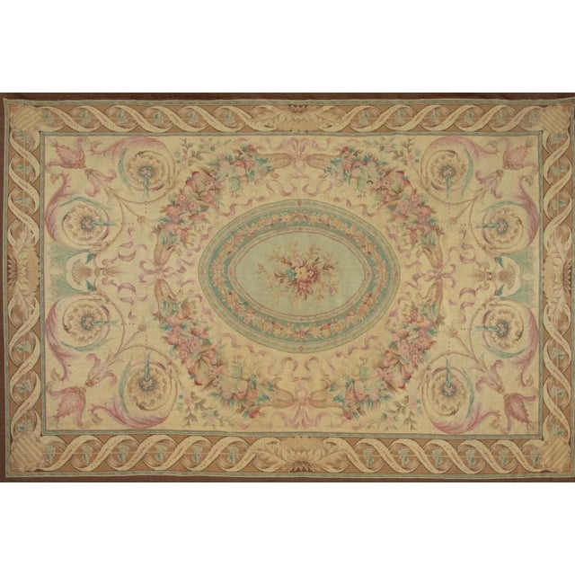 Handwoven in wool, this 6x9 circa 1800-1850, antique French Aubusson petit-point tapestry reflects the elegance of early...