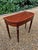 A Regency Mahogany D-Shaped Card Table with Rosewood inlay and banding on turned reeded tapered legs. The two back legs...