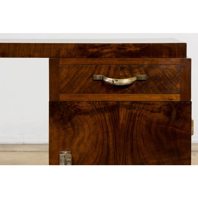 A refined French Art Deco desk sourced in Paris, dating to the 1930s. The piece is defined by its exceptional walnut burl...