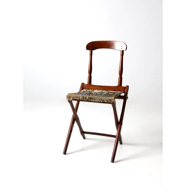 This late 19th century Readsboro Chair Mfg. Co. folding campaign chair features a turned wood frame, curved crest rail,...