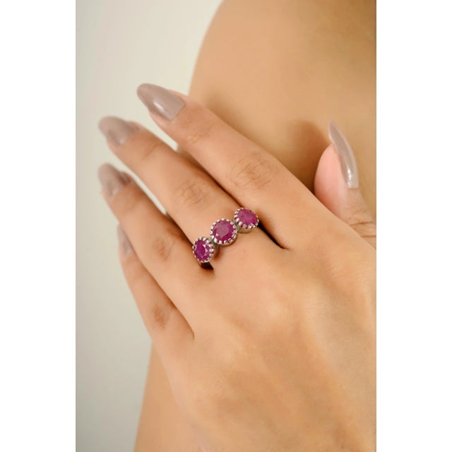 Elevate your collection with this captivating three-stone ring, handcrafted in luminous 14k white gold. Featuring a total...