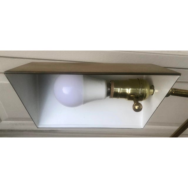 Heavy brass reading floor lamp with round base and tent shade. Ball switch is a dimmer that also turns it on and off. Arm...