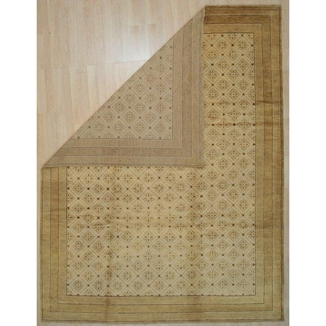 This hand knotted pile rug features a primary color palette of ivory, beige, cream, and white. Crafted from wool, this...