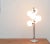 This is an imposing space age table lamp with six glass balls. The diffuser 6 balls made of opal glass are arranged at...
