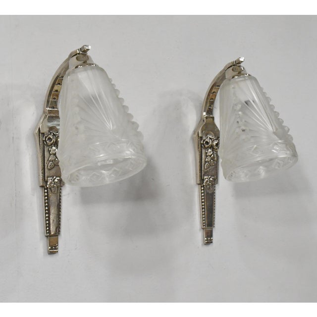 Charles Schneider A pair of French art deco floral motif wall sconces circa 1925-1935 in nickel-plated cast bronze or...