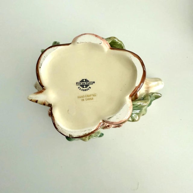 Coral, shells and seaweed adorn this charming sugar and creamer by Fitz and Floyd Classics. The base color is a slightly...