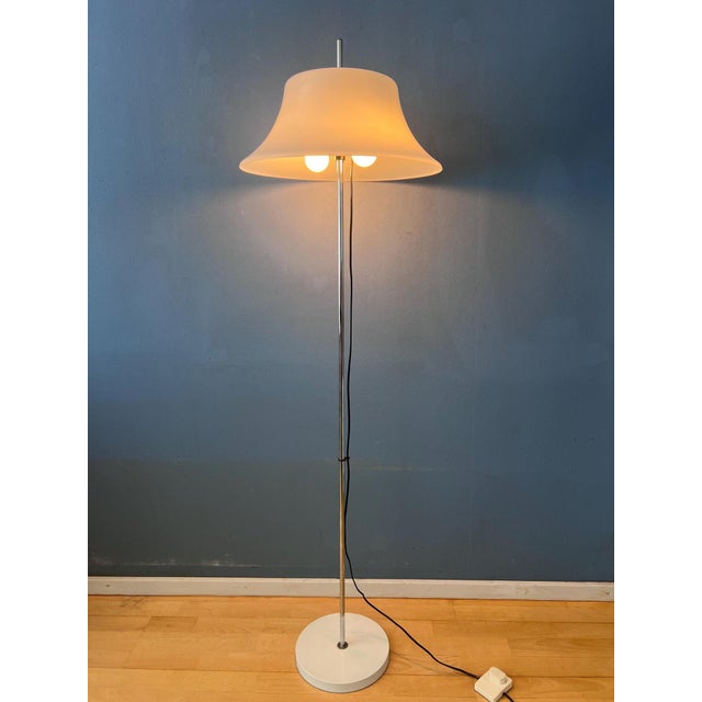 Very rare space age floor lamp featuring a large white acrylic glass shade with a sleek futuristic design. The acrylic...