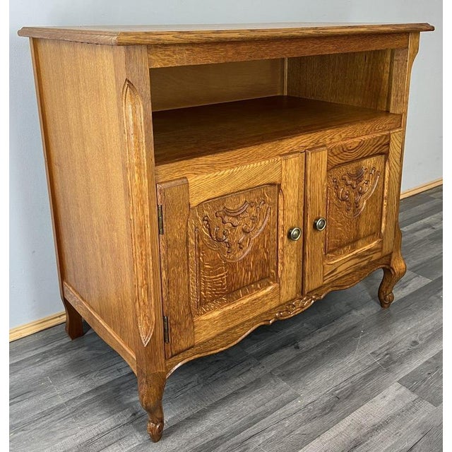 A charming Vintage French Louis cabinet , beautifully shaped with elegant curves, decorative carved door panels and a warm...