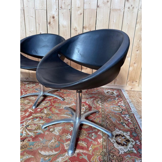 Set of four swivel armchairs with spherical shells, Karisma edition, circa 1980. The bowl-shaped shell features a...