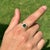 This Halo ring showcases a striking 1.22 carat green tourmaline set in 14K yellow gold. The tourmaline measuring 5.5 x 5.5...