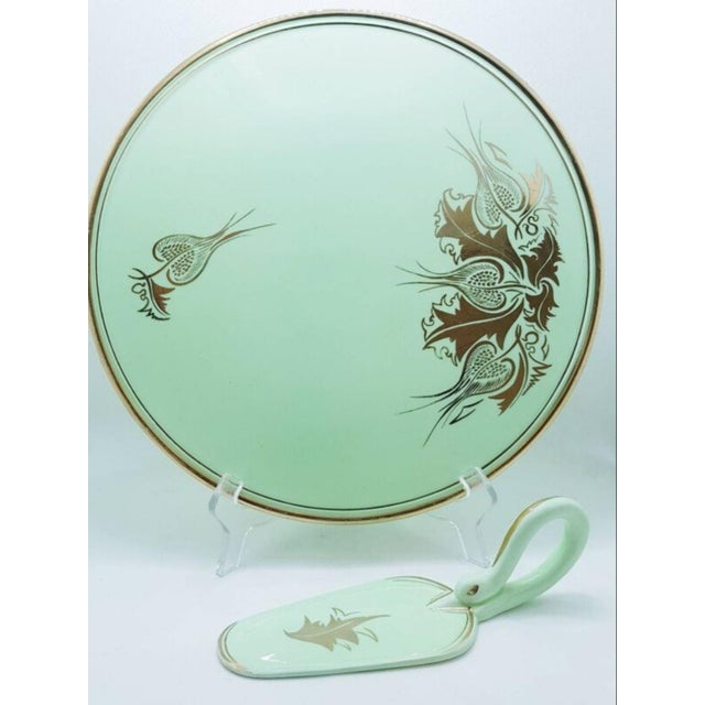 Mint coloured ceramic cake plate with ceramic server and gold detailing. Both pieces were hand painted by r. P. Cerel,...