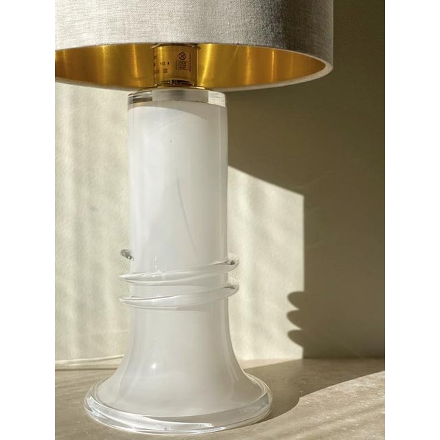 Atelje Lyktan Glass Table Lamp with brass stem. White, Milky Glass. Produced and manufactured in Sweden during the 1980s....