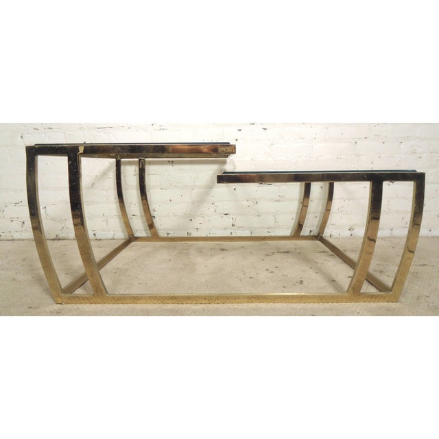 Unusual cocktail table in the style of Milo Baughman, with dual layer glass levels. Nicely beveled glass, formed base,...