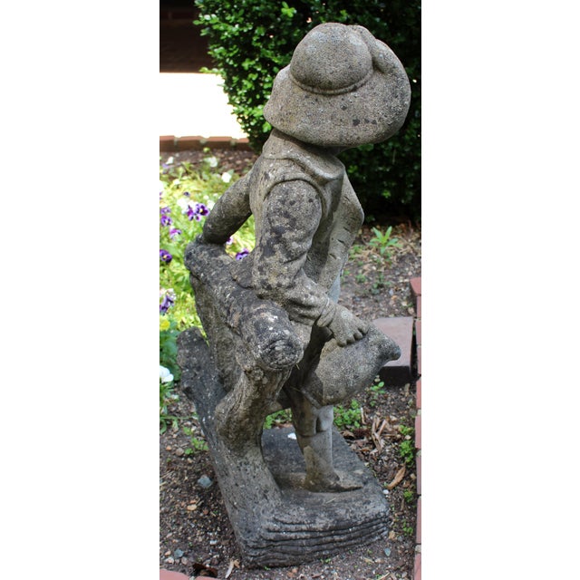 Mid-20th century English cast stone garden fountain statue of a boy. He is piped through his leg to the jug he holds in...