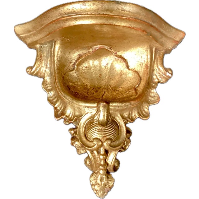 A Pair of Italian Rococo Style Gold Gilt Wall Brackets. Brackets feature impressive gold scrolling with floral motif. Top...