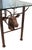 A vintage iron table featuring two stags with sculptural intertwined antlers and a glass top.