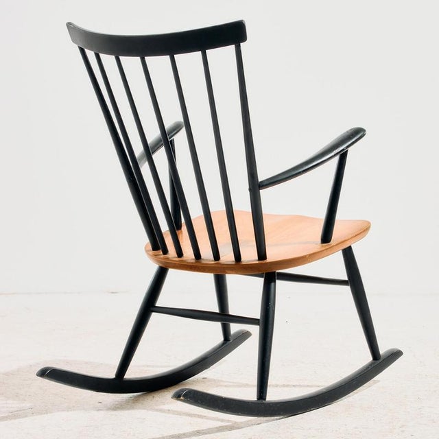 Timeless Swedish design and comfort. Beech rocking chair with high backrest from the 1960s, designed by Roland Rainer for...