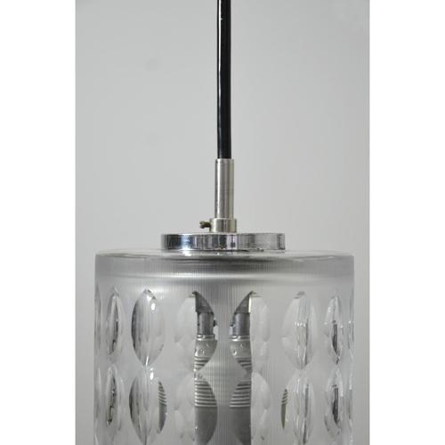 Small pendant light with shade made of crystal glass. The glass is textured by grinding and furthermore ground out...