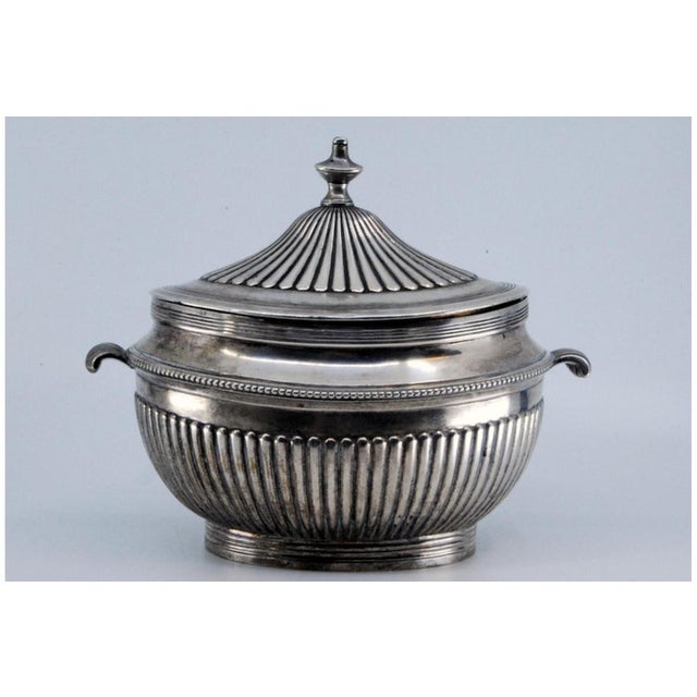 Sugar Bowl in Fluted Silver with Pearly Frieze and Outer Handles, in Very Good conditions. Designed before 1890 This piece...