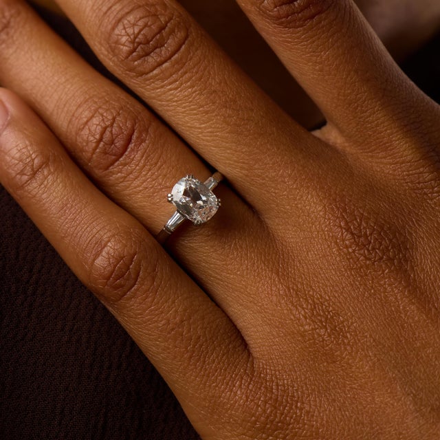 This elegant Mid Century engagement ring centers on a striking 1.53 carat old mine cut diamond, certified by GIA...