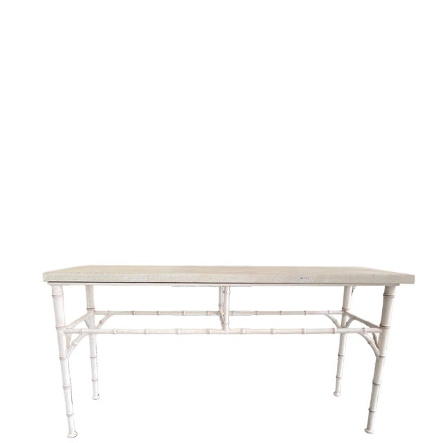 A refined outdoor console table by Michael Taylor, designed with a clean architectural profile and a bamboo-inspired metal...