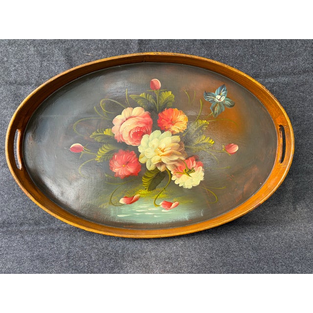 Pretty, vintage hand painted wood floral tole, oval tray with a complimentary wide brown rim and cutout side handles....