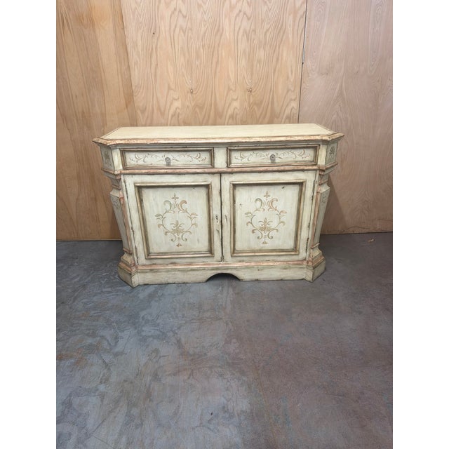 Italian Provincial sideboard by Century Furniture, featuring a softly distressed painted finish with hand-painted floral...