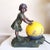 Here we have a nice statue lamp, art deco/art nouveau style, and yellow and blue colored glass/frosted sphere shade: “pate...