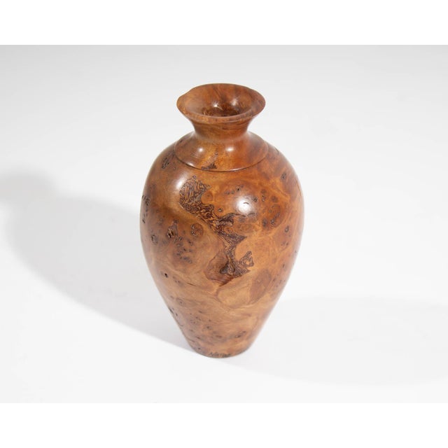 A wooden vase by New Zealand artisan Jim Robbie. Vase is made from Tawhai Burr wood. Signed to the bottom edge and marked...