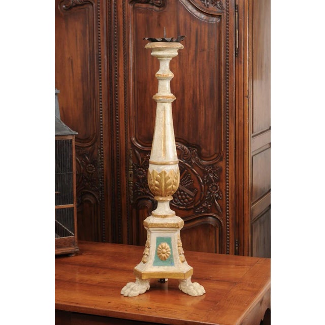 An 18th century painted and gilded candlestick from Tuscany, with fluted motifs and acanthus leaves. Created in central...
