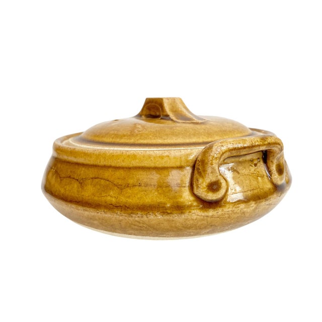 This Vintage Studio Pottery Small Casserole Dish in a warm mustard-brown hue is a perfect blend of rustic charm and...