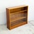 A low bookcase by gibbs furniture, with two sliding glass doors across the full front. It's a simple box, and the timber...