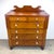 An impressive mid 19th century cherry wood chest of drawers with glass drawer pulls and scroll top. Professionally...