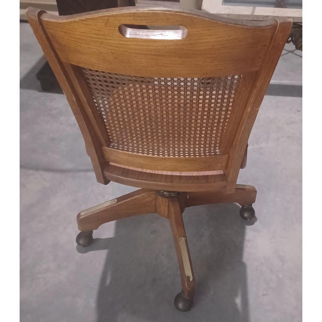 Indulge in the enduring allure of mid-century design with our exquisite Mid-Century Cane Back Swivel Office Chair. This...