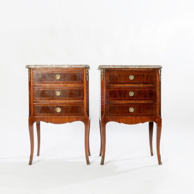 Pair of beautiful French Louis XV style ormolu mounted 3 drawer marble top stands.